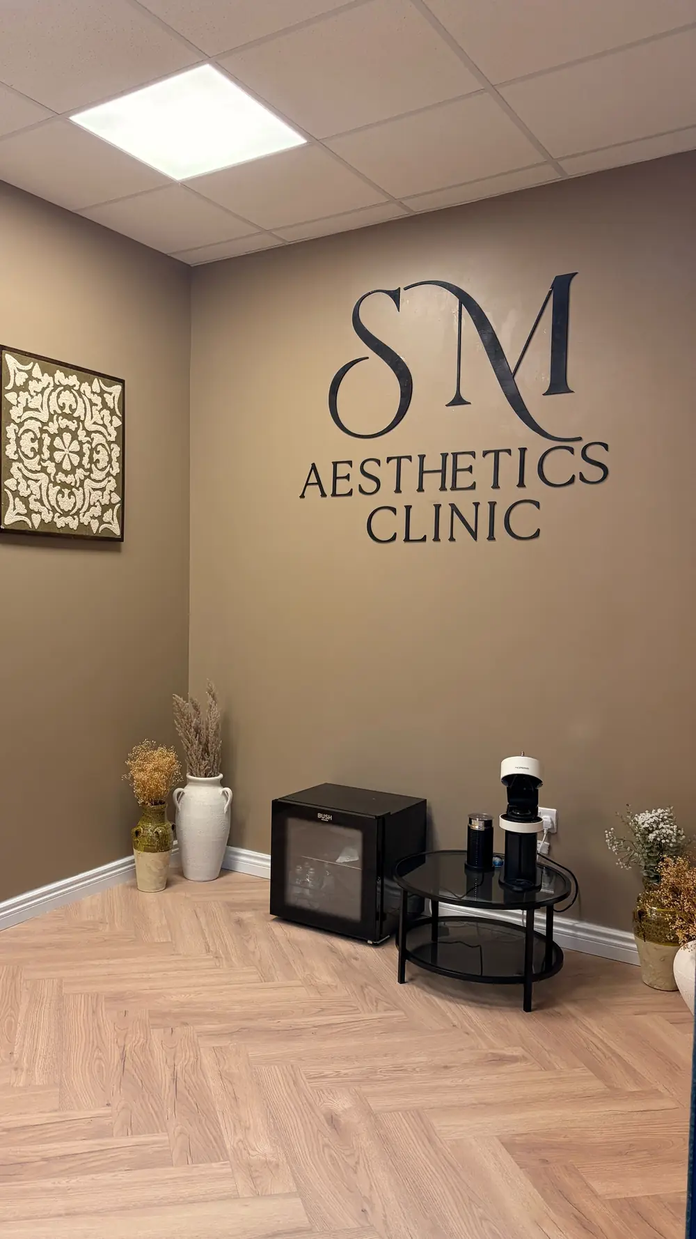 SM Aesthetics Clinic logo on the reception wall